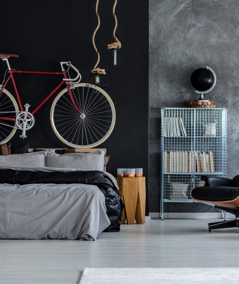 Modern designed bedroom with red bicycle above the bed