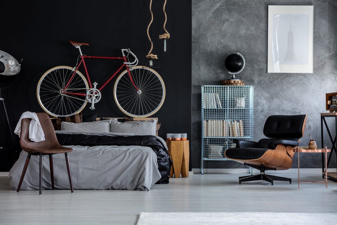 Modern designed bedroom with red bicycle above the bed
