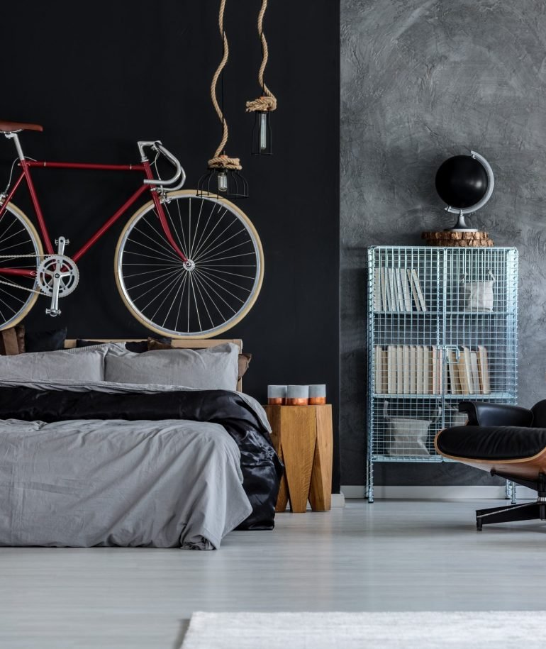 Modern designed bedroom with red bicycle above the bed