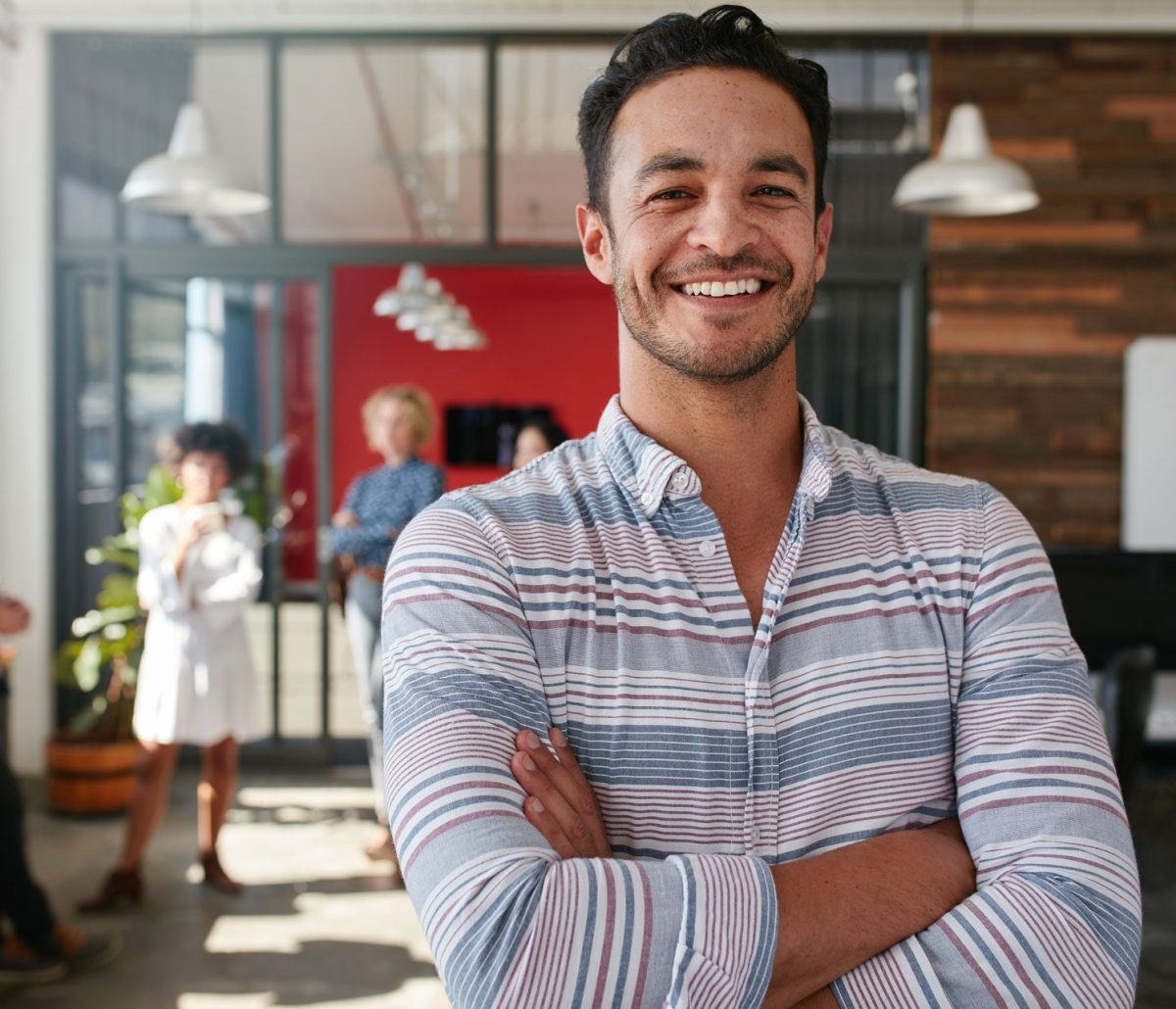 smart-young-male-designer-with-his-colleagues-in-b-PGVQLSZ