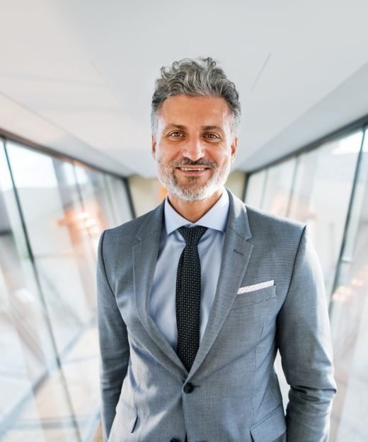 Handsome mature businessman walking in the corridor, travelling.